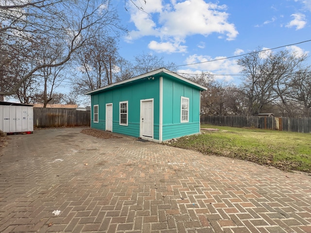 view of outdoor structure featuring a lawn