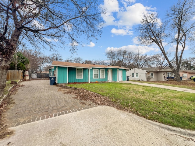 ranch-style home with a front lawn