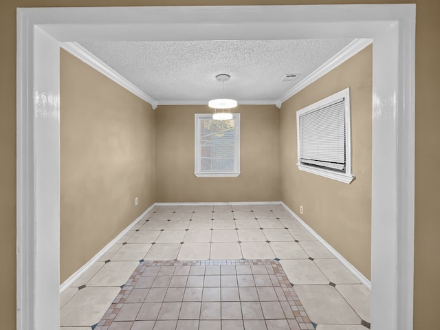 spare room with a textured ceiling, light tile patterned floors, and ornamental molding