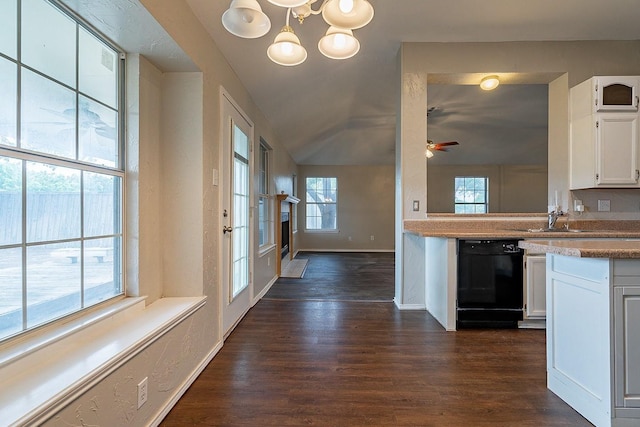 kitchen featuring ceiling fan with notable chandelier, white cabinetry, black dishwasher, and lofted ceiling