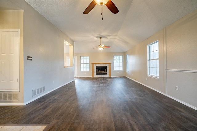 unfurnished living room featuring a fireplace, dark hardwood / wood-style floors, ceiling fan, and lofted ceiling