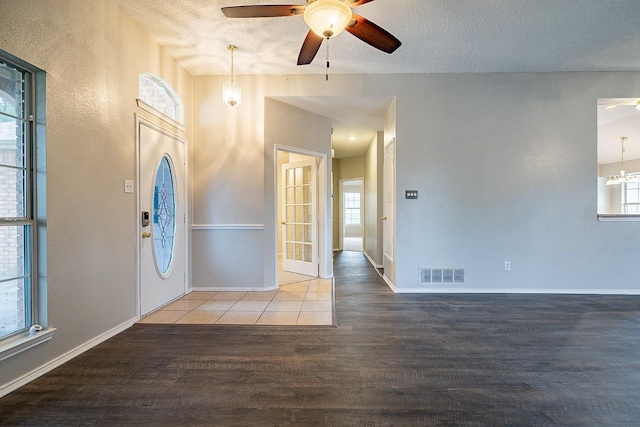 entryway with hardwood / wood-style flooring, ceiling fan, and a textured ceiling