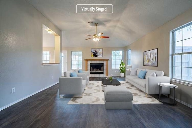 living room with ceiling fan, a fireplace, dark hardwood / wood-style floors, and lofted ceiling