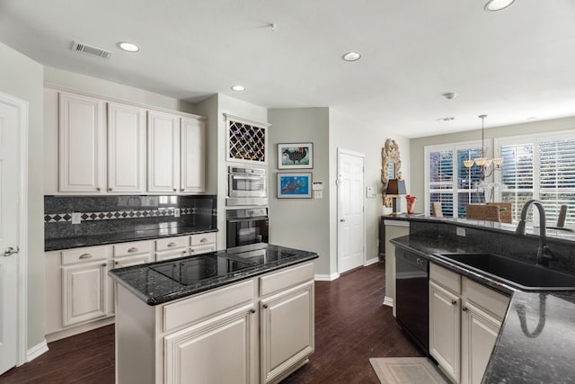 kitchen with sink, decorative light fixtures, an inviting chandelier, dishwasher, and a center island