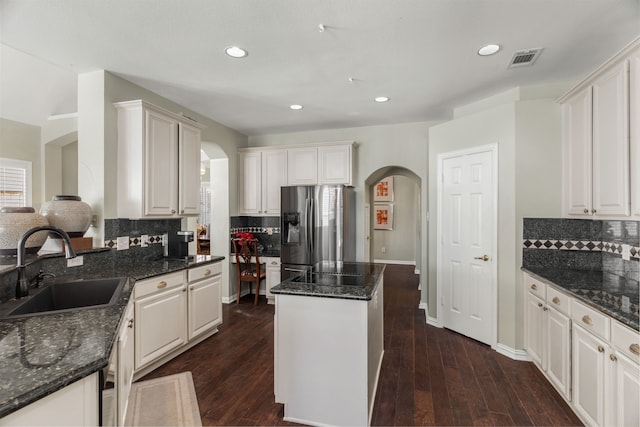 kitchen with sink, white cabinetry, and stainless steel refrigerator with ice dispenser