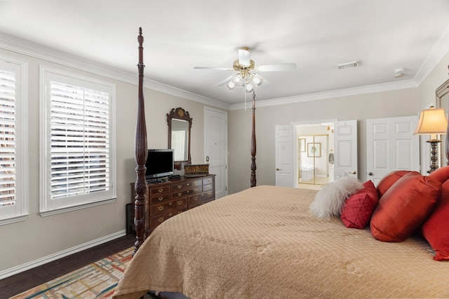 bedroom with ceiling fan, dark hardwood / wood-style flooring, crown molding, and connected bathroom