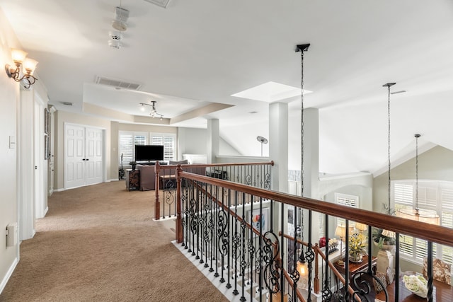 hall featuring light carpet and lofted ceiling