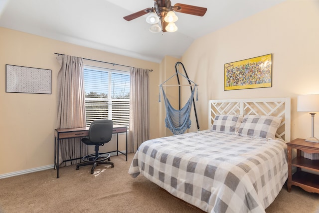 bedroom with ceiling fan, light colored carpet, and vaulted ceiling