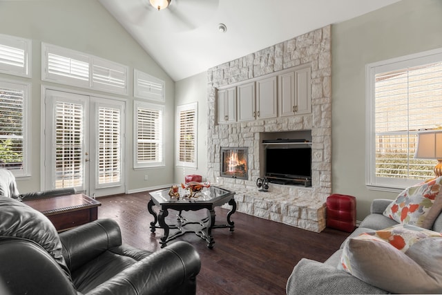 living room featuring vaulted ceiling, ceiling fan, a fireplace, and dark hardwood / wood-style floors