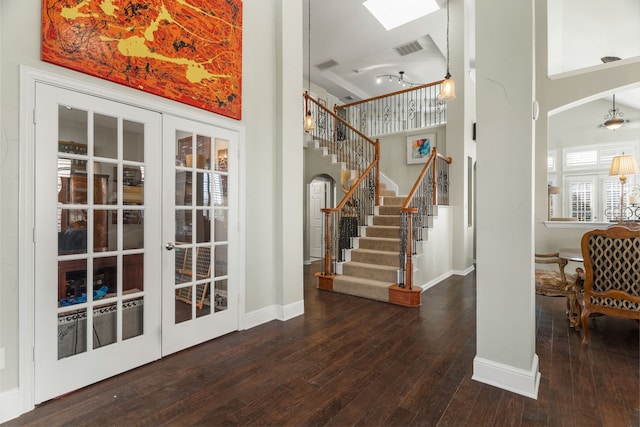 foyer featuring french doors, dark hardwood / wood-style floors, and a high ceiling