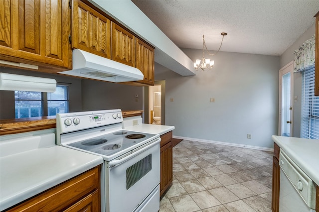 kitchen featuring white appliances, a textured ceiling, pendant lighting, a chandelier, and light tile patterned flooring