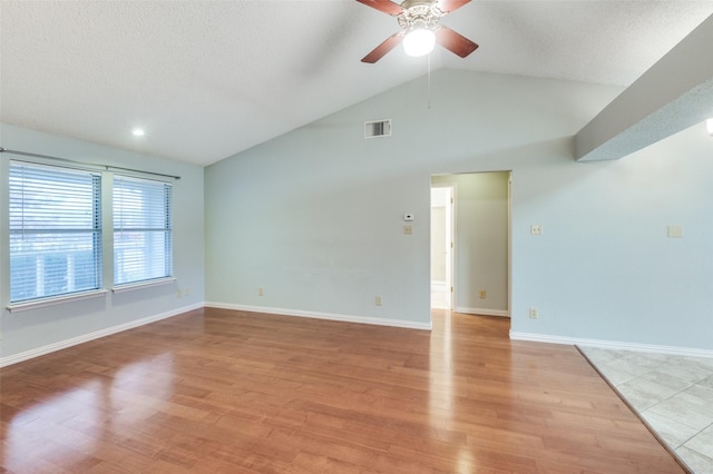 unfurnished room featuring ceiling fan, lofted ceiling, and light wood-type flooring