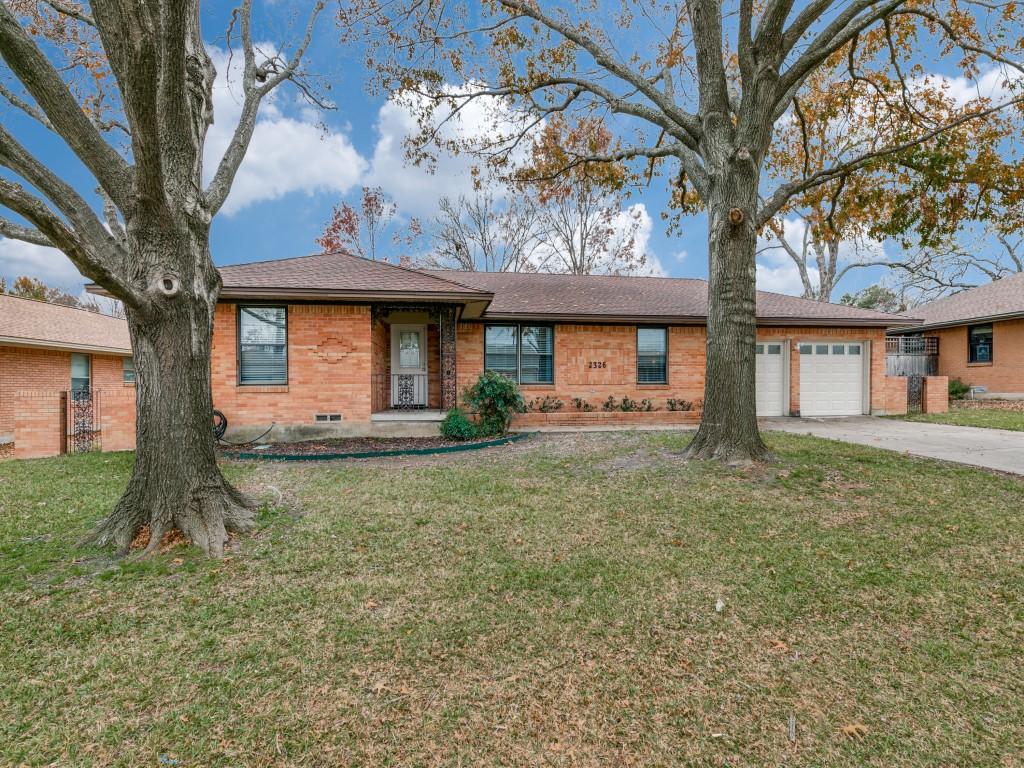 ranch-style home featuring a garage and a front yard