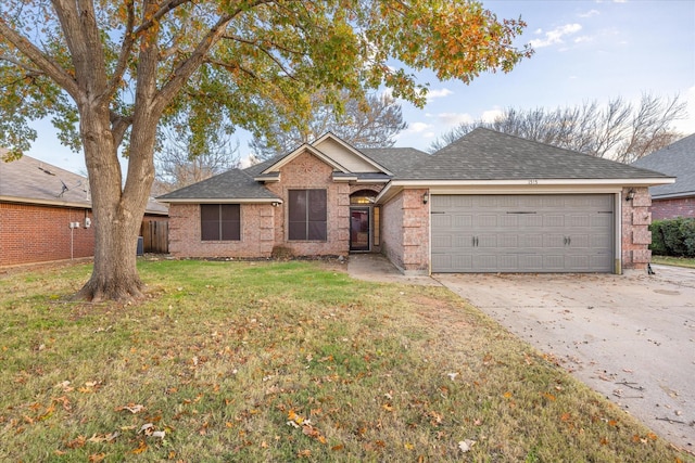 ranch-style house with a garage and a front lawn