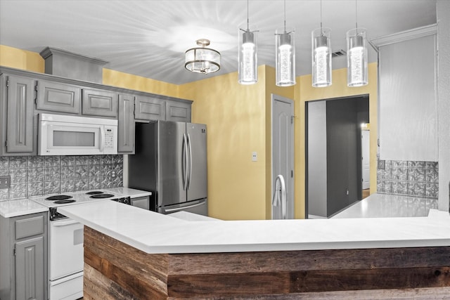 kitchen featuring decorative light fixtures, gray cabinets, decorative backsplash, and white appliances