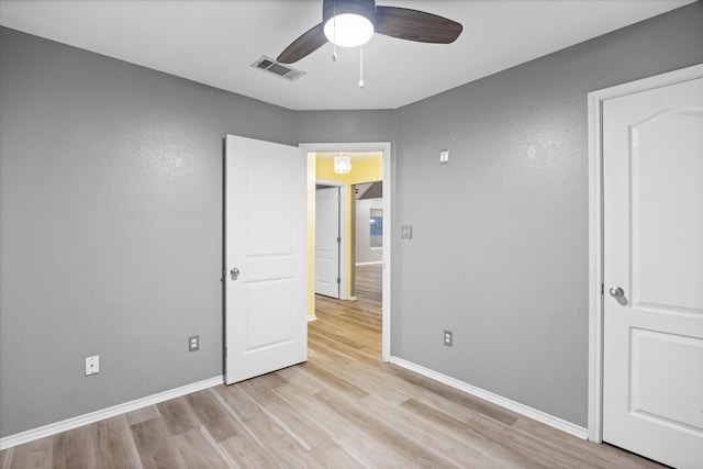 unfurnished bedroom with ceiling fan and light hardwood / wood-style flooring