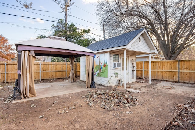 exterior space with a gazebo, cooling unit, and an outdoor structure