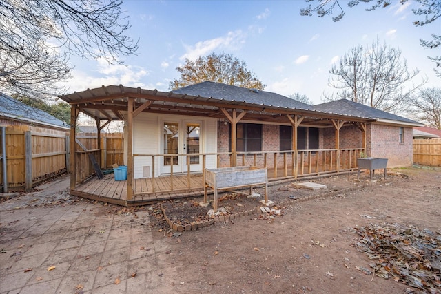 back of house with french doors and a wooden deck