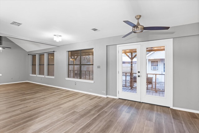 unfurnished room with french doors, vaulted ceiling, ceiling fan, and wood-type flooring