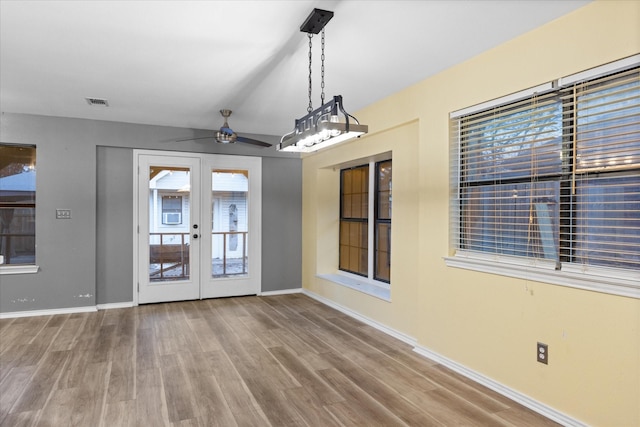 unfurnished room with french doors, hardwood / wood-style flooring, and ceiling fan