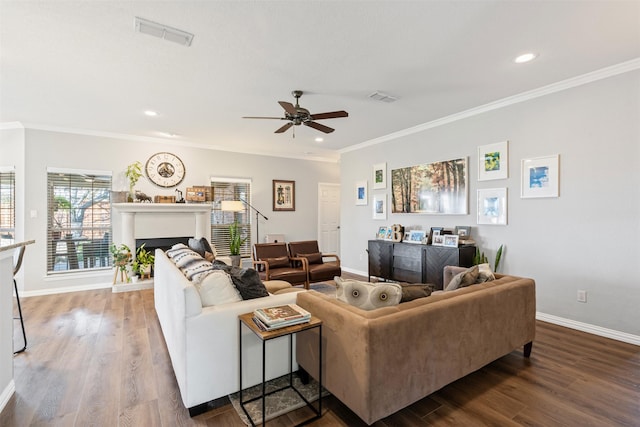 living room featuring hardwood / wood-style flooring, ceiling fan, and ornamental molding