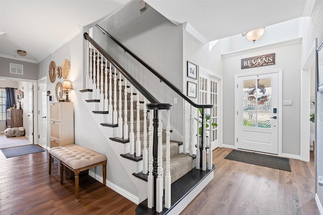 foyer with hardwood / wood-style flooring and crown molding