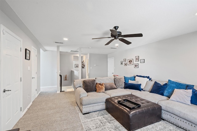 carpeted living room with ceiling fan