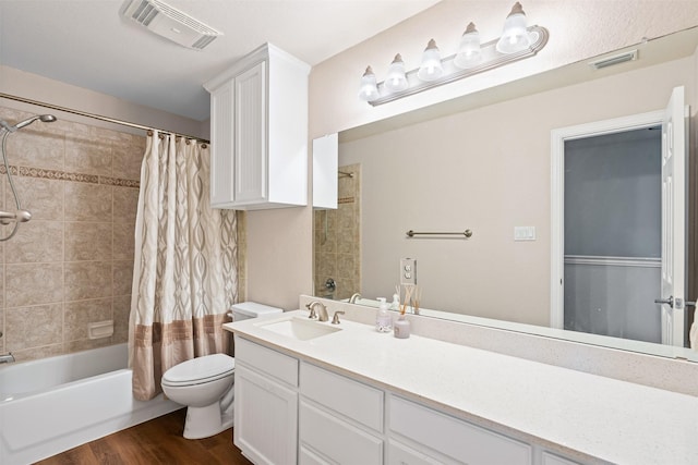 full bathroom featuring wood-type flooring, vanity, shower / bath combination with curtain, and toilet