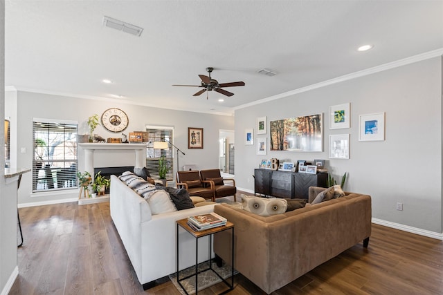 living room with dark wood-type flooring, ceiling fan, and ornamental molding