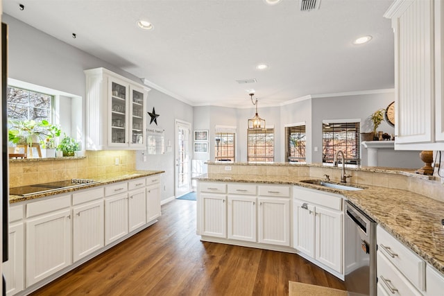 kitchen with black electric stovetop, white cabinets, sink, pendant lighting, and dishwasher