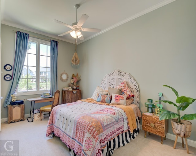 carpeted bedroom featuring ceiling fan and ornamental molding