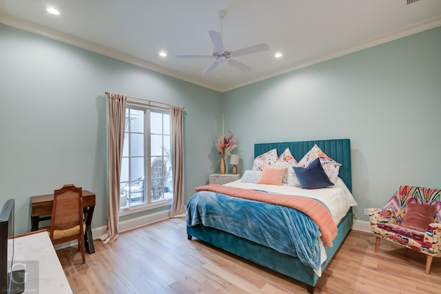 bedroom featuring hardwood / wood-style flooring, ornamental molding, and ceiling fan