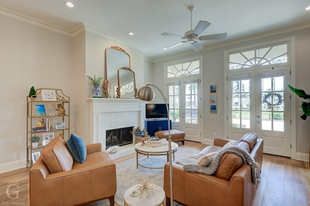 living room featuring french doors, a healthy amount of sunlight, and crown molding