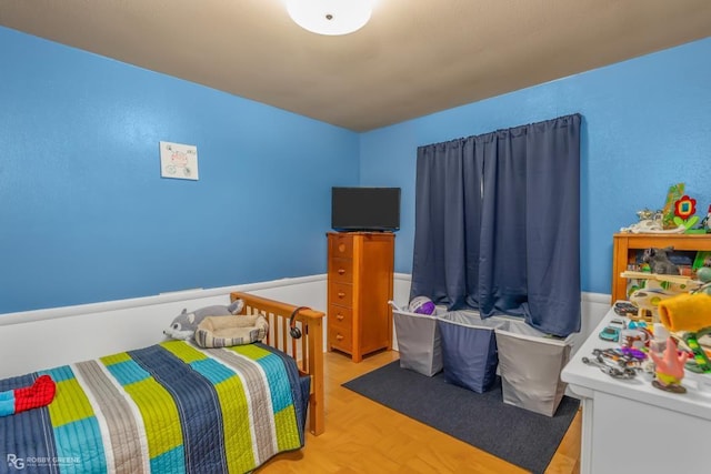 bedroom featuring light parquet flooring