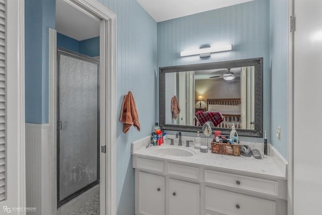 bathroom with ceiling fan, walk in shower, and vanity