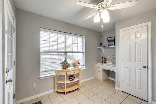 tiled office featuring ceiling fan