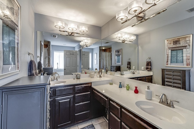 bathroom featuring tile patterned flooring, vanity, and an inviting chandelier