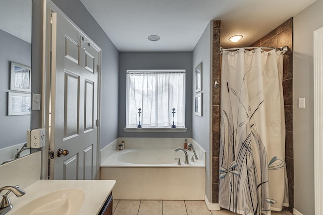 bathroom featuring tile patterned floors, vanity, and shower with separate bathtub