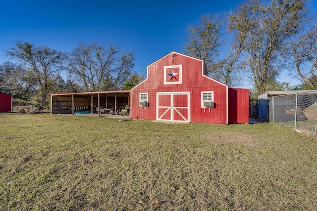 view of outdoor structure featuring a lawn and cooling unit