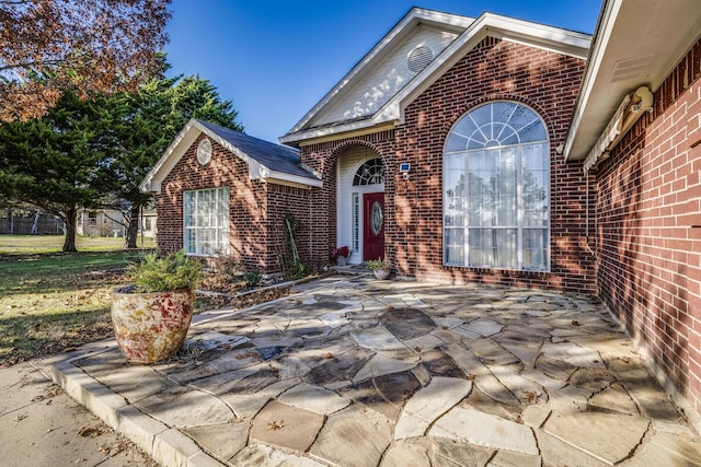 entrance to property with a patio