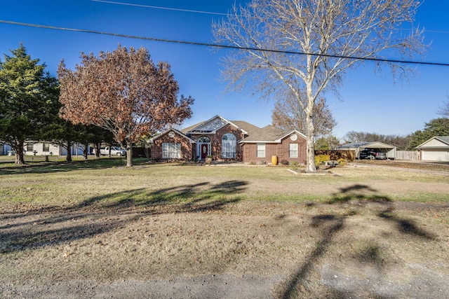 view of front of property with a front yard and a carport