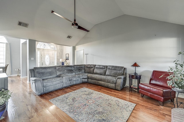 living room with wood-type flooring, ceiling fan, and lofted ceiling