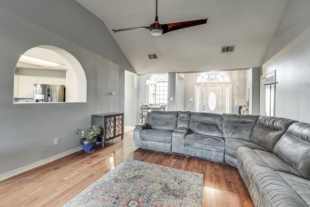 living room with hardwood / wood-style flooring, vaulted ceiling, and ceiling fan