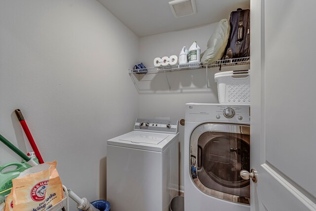 clothes washing area with washing machine and dryer