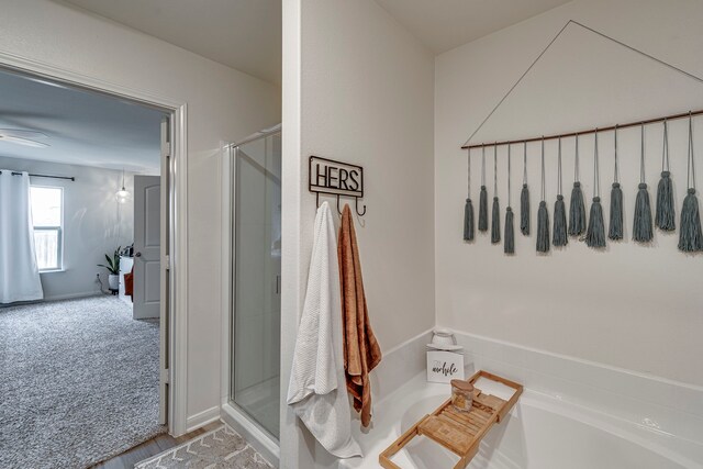 bathroom featuring a shower with door