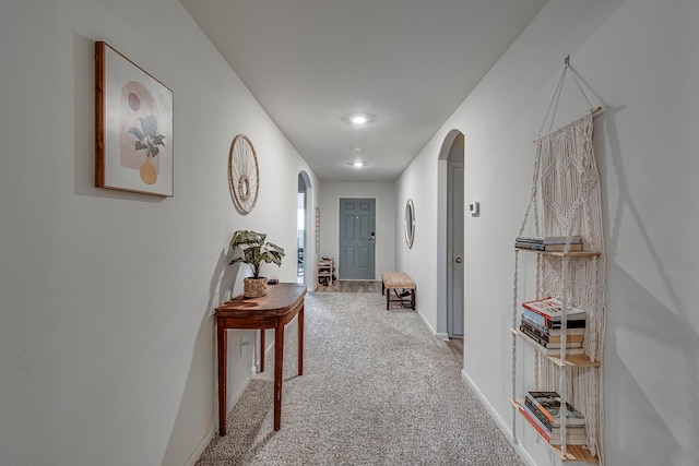 corridor featuring light colored carpet