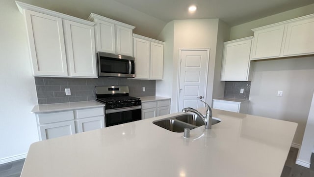 4224 Lucy Ln, Sherman, TX 75090 - kitchen featuring stainless steel appliances, a sink, baseboards, white cabinets, and recessed lighting