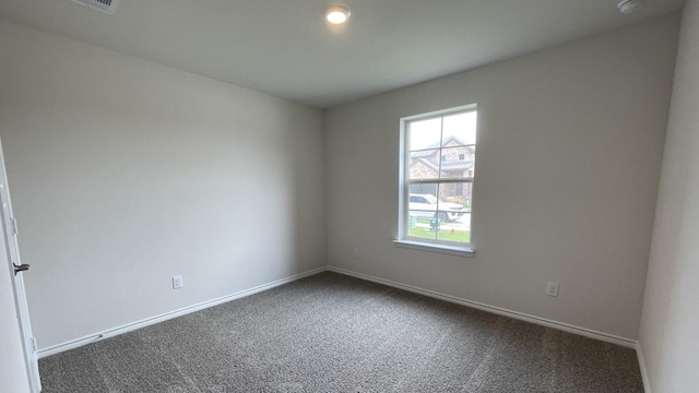 4224 Lucy Ln, Sherman, TX 75090 - spare room featuring dark colored carpet and baseboards