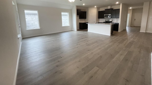 4219 Sky Dr, Sherman, TX 75090 - kitchen featuring appliances with stainless steel finishes, open floor plan, light wood-type flooring, ceiling fan, and recessed lighting
