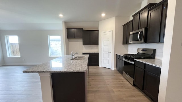 4219 Sky Dr, Sherman, TX 75090 - kitchen with appliances with stainless steel finishes, a sink, backsplash, light wood-style flooring, and recessed lighting